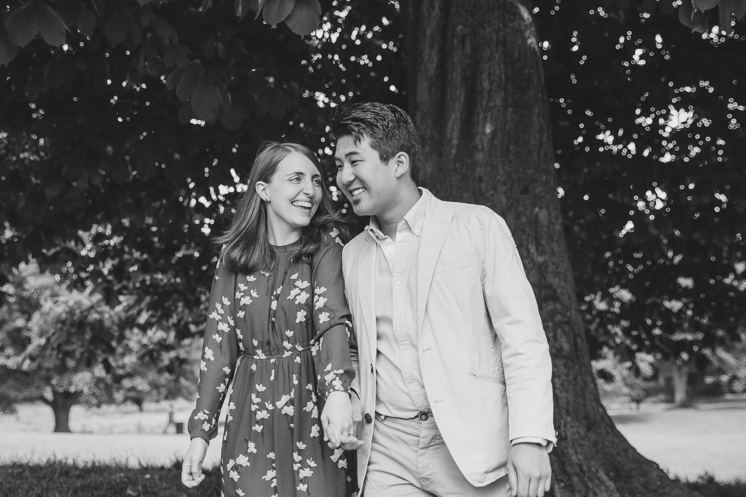 Black and white photo of engaged couple in Ely. Photographed by Ely Photographer. Couple standing by a tree.