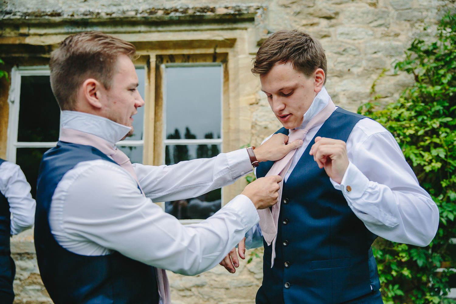 Picture of two men getting ready for a wedding.