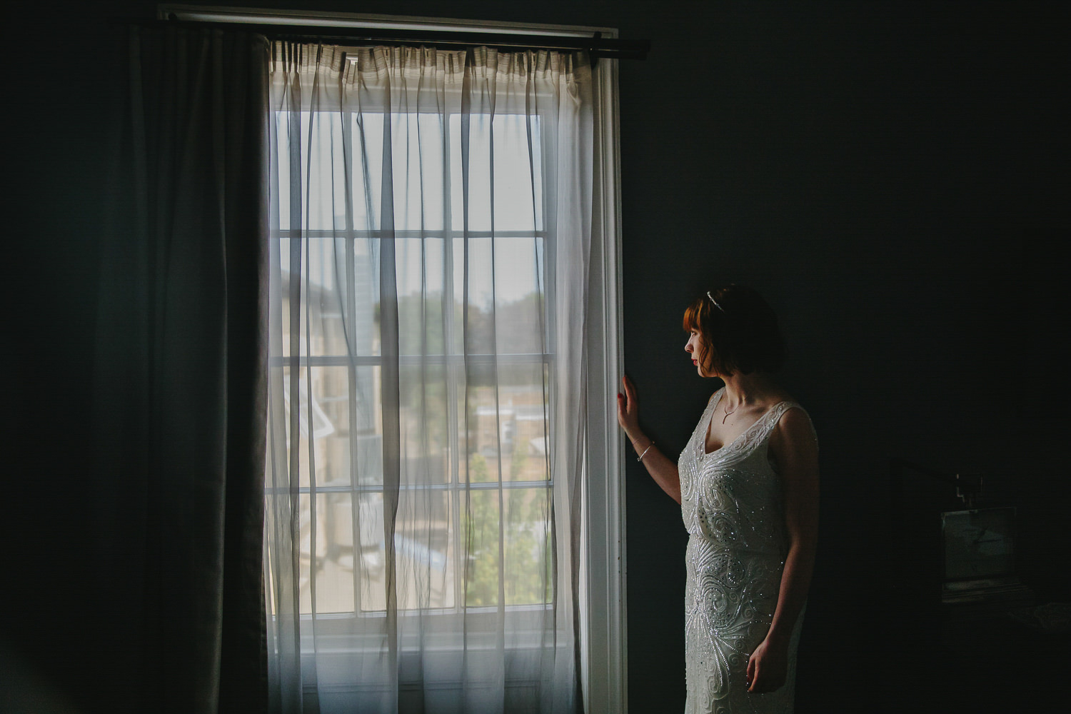 Bride looking out of a window