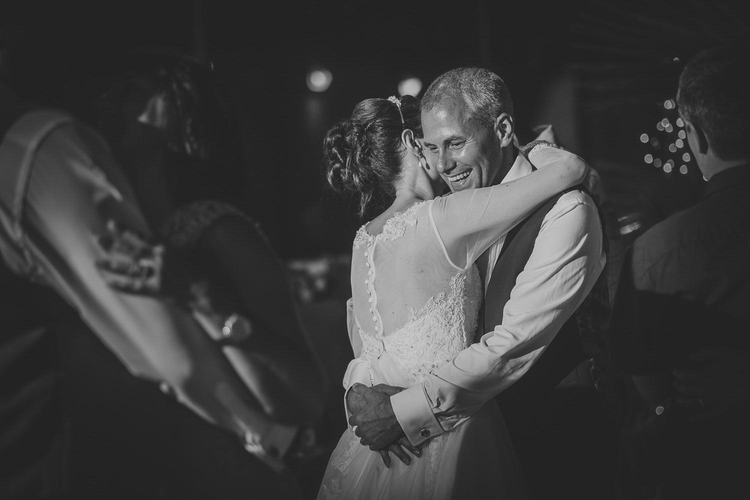 Bride and groom hugging and dancing.