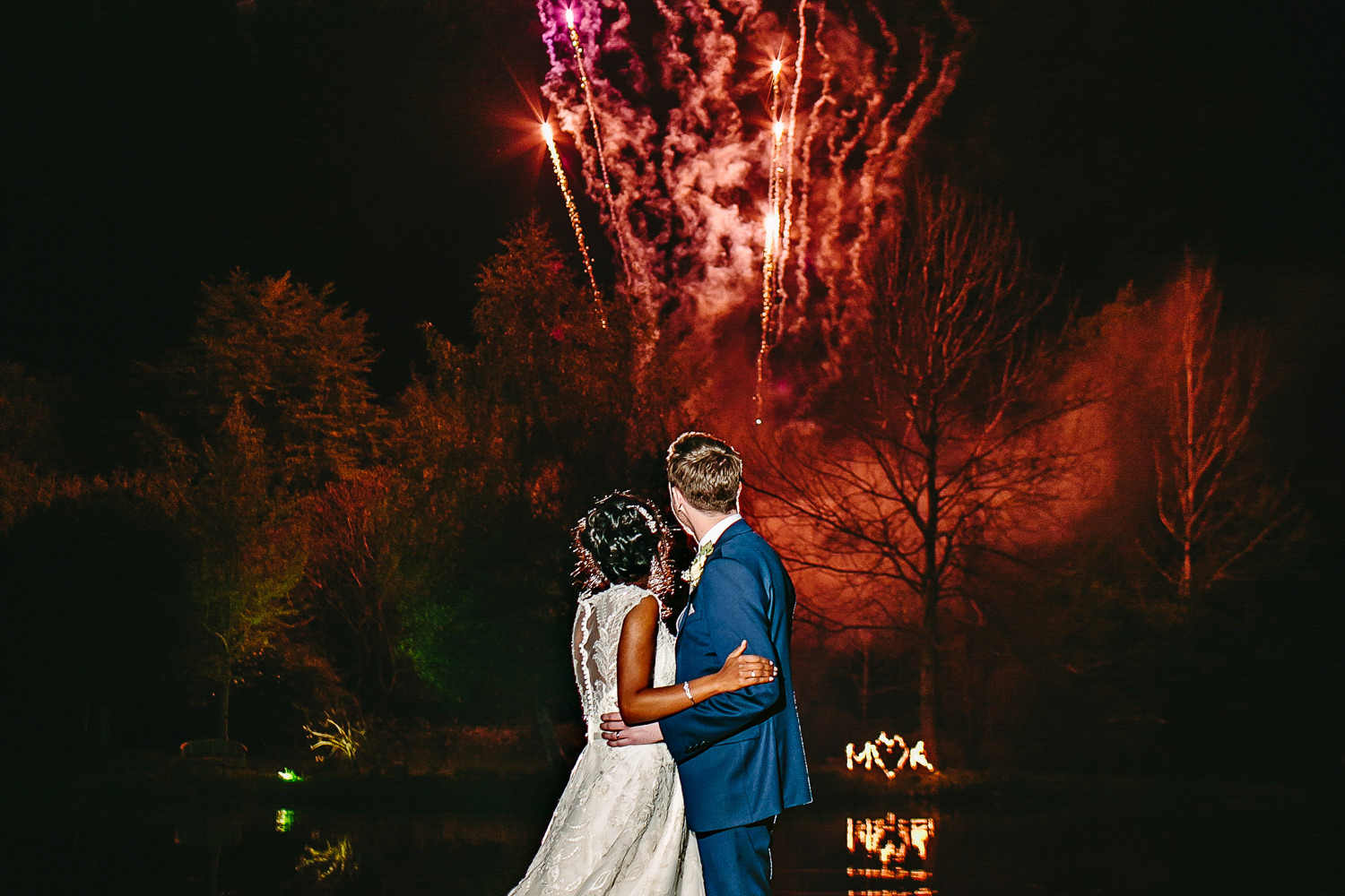 Bride and groom looking at fireworks
