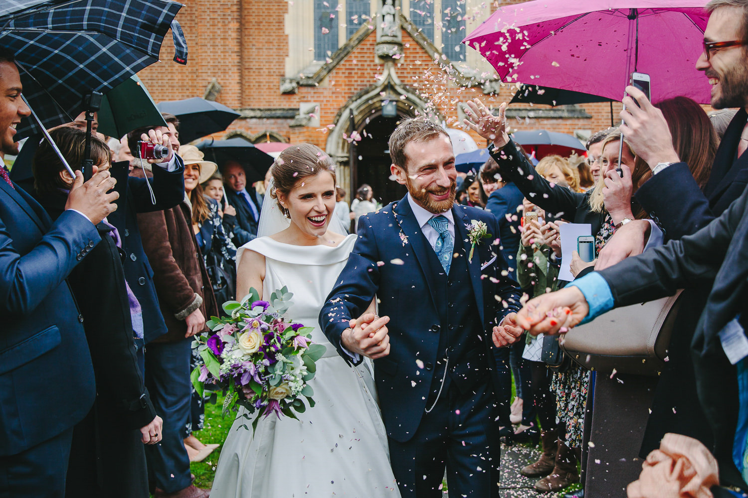 Bride and groom in front of church with confetti