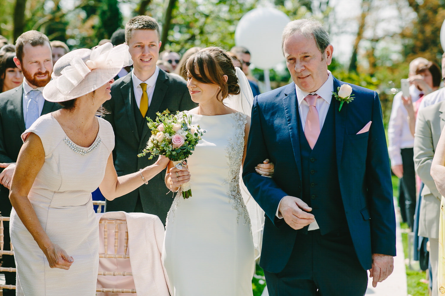 Bride with mother and father at beginning of wedding ceremony