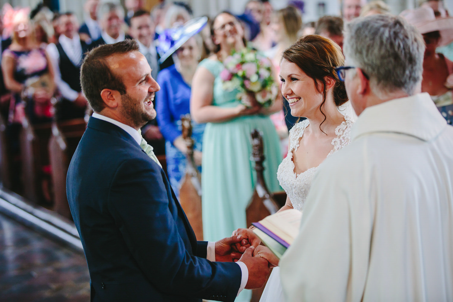 Bride and groom smiling during church wedding ceremony