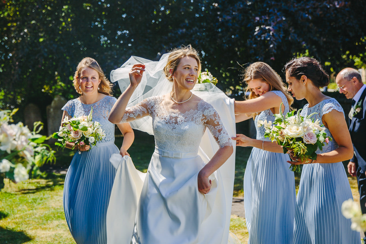 Bride and bridesmaids walking in sunshine