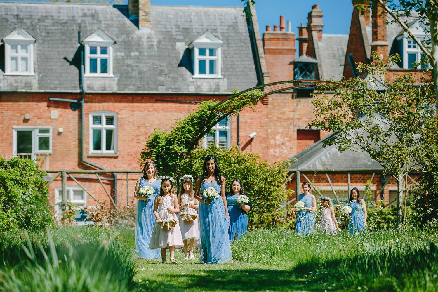 Brides maids walking through meadow