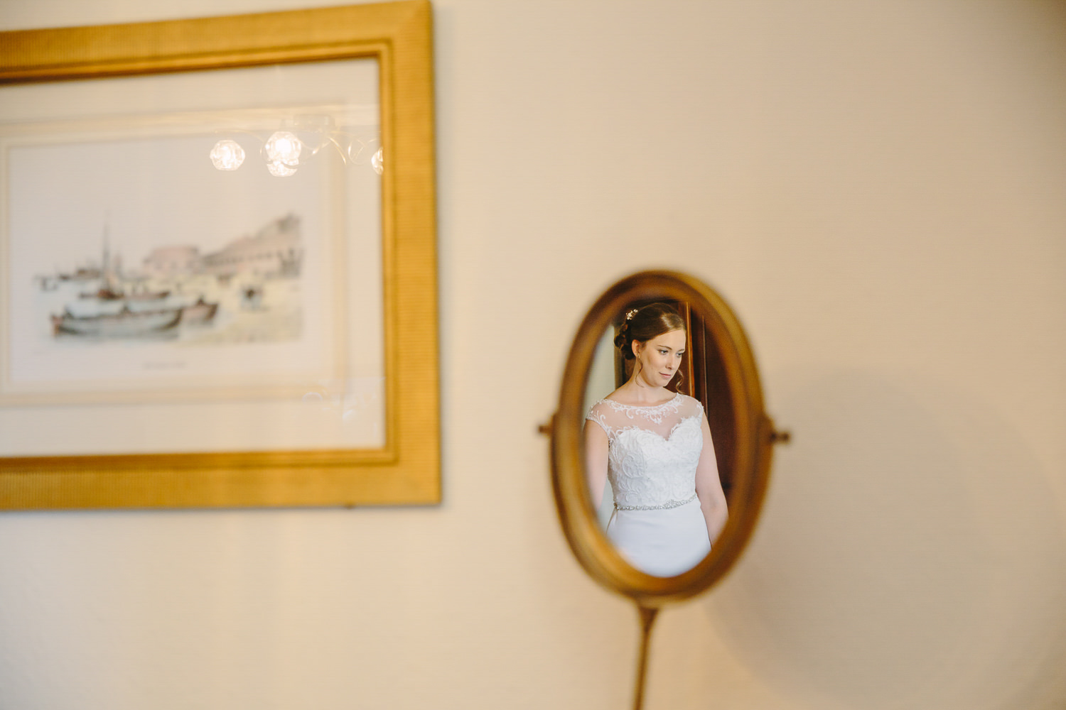 Reflection of bride in small mirror