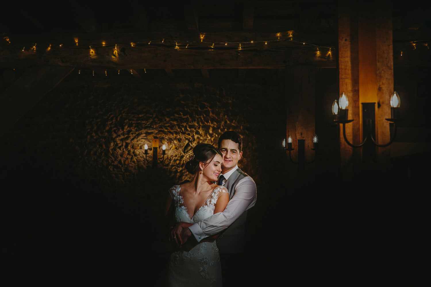 Bride and groom indoor portrait, with fairy lights and lanterns