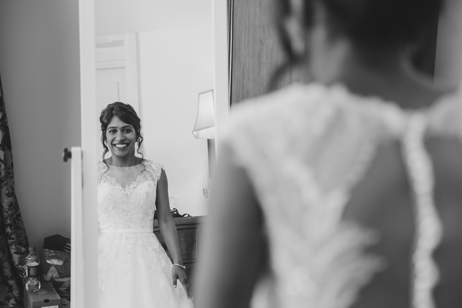 Bride looking in a mirror.