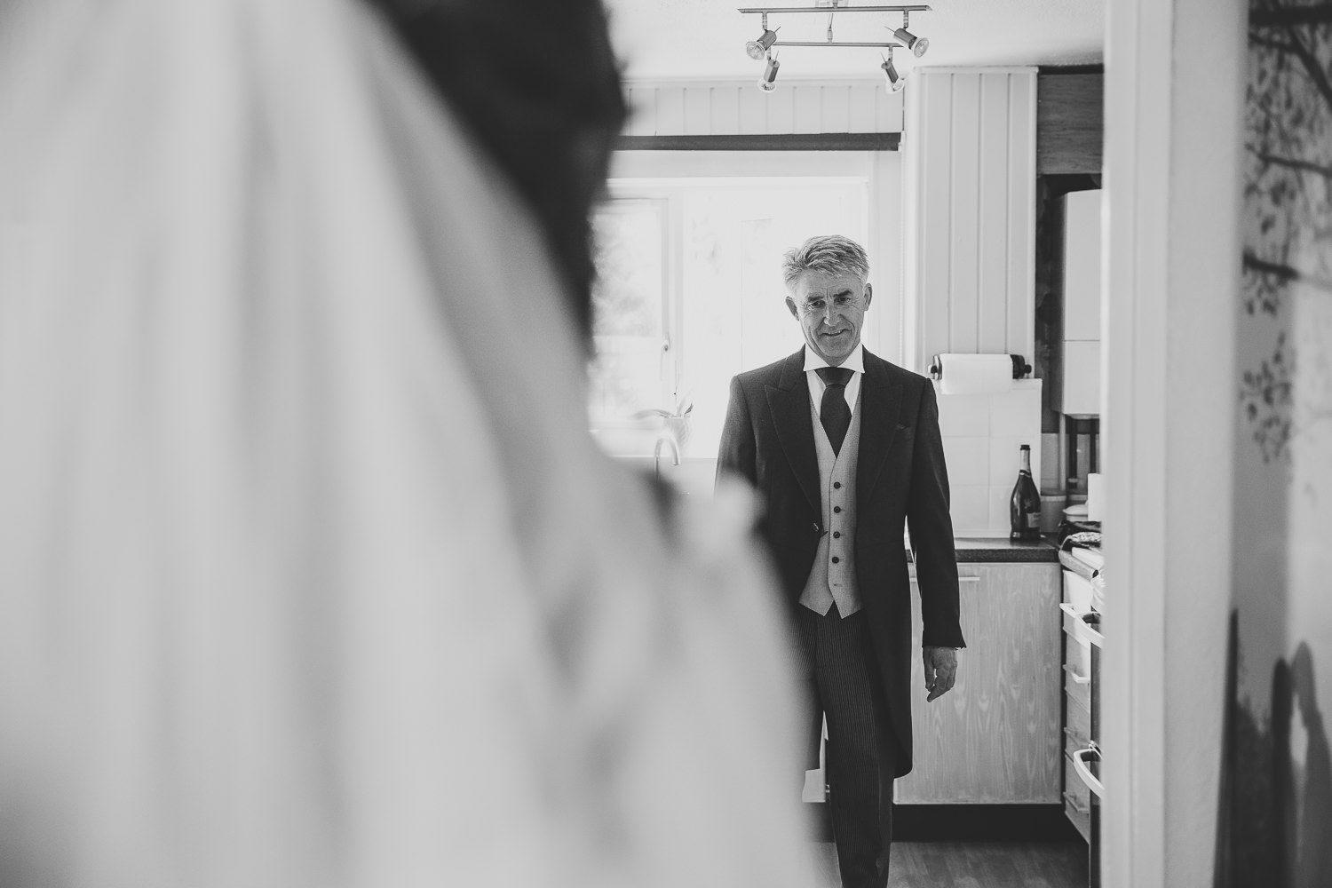 Black and white wedding photo of father greeting his daughter on her wedding day