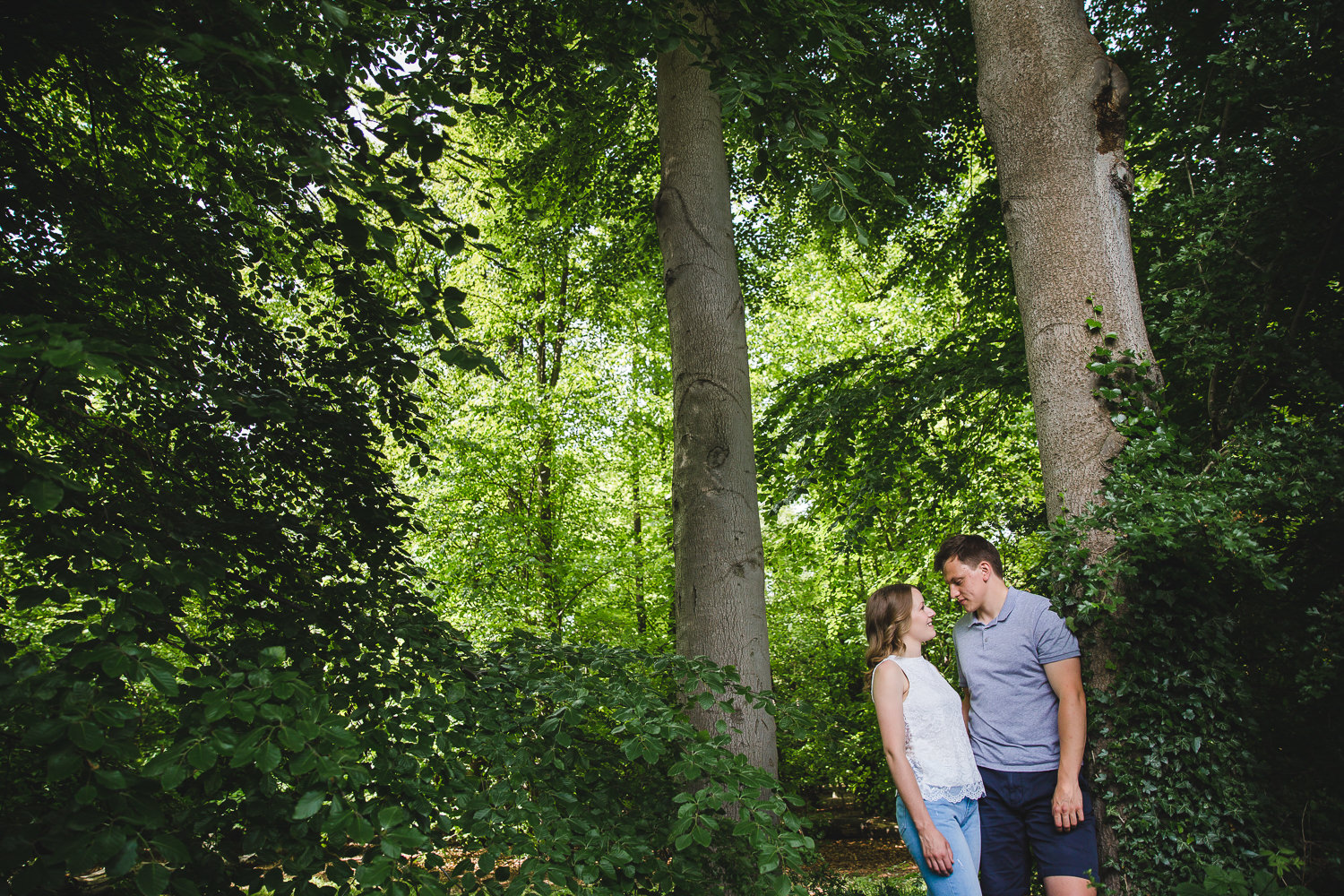 Engagement shoot photo of a couple in the woods, in Wandlebury country park in Cambridge.