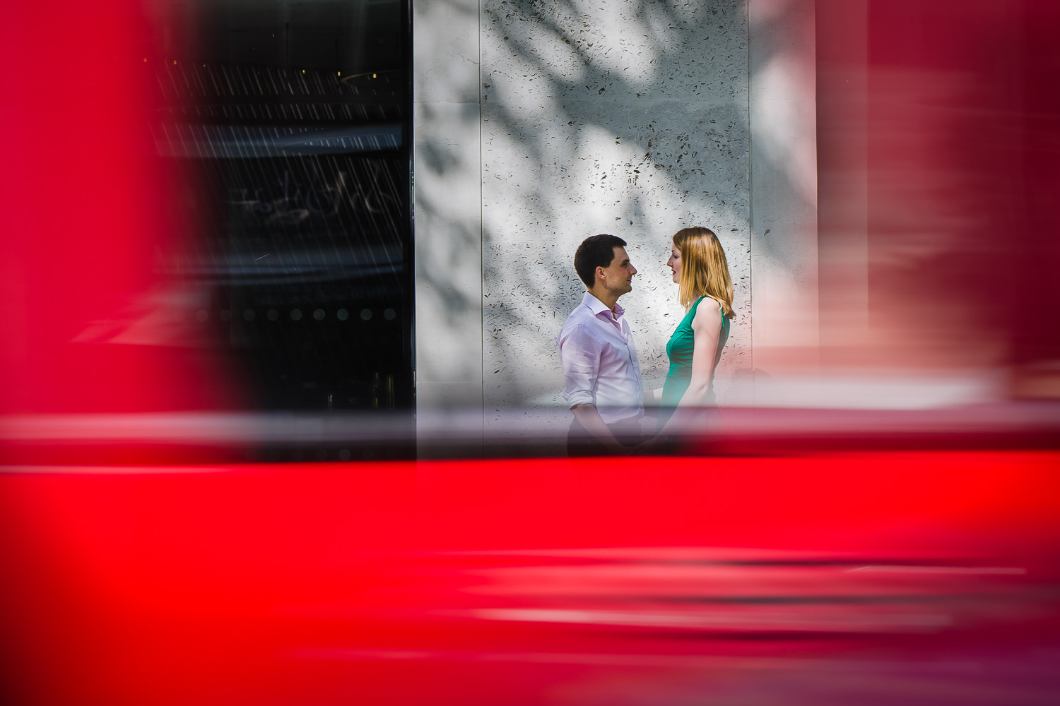 Creative engagement photo of couple who can be seen through the window of a London Red Bus