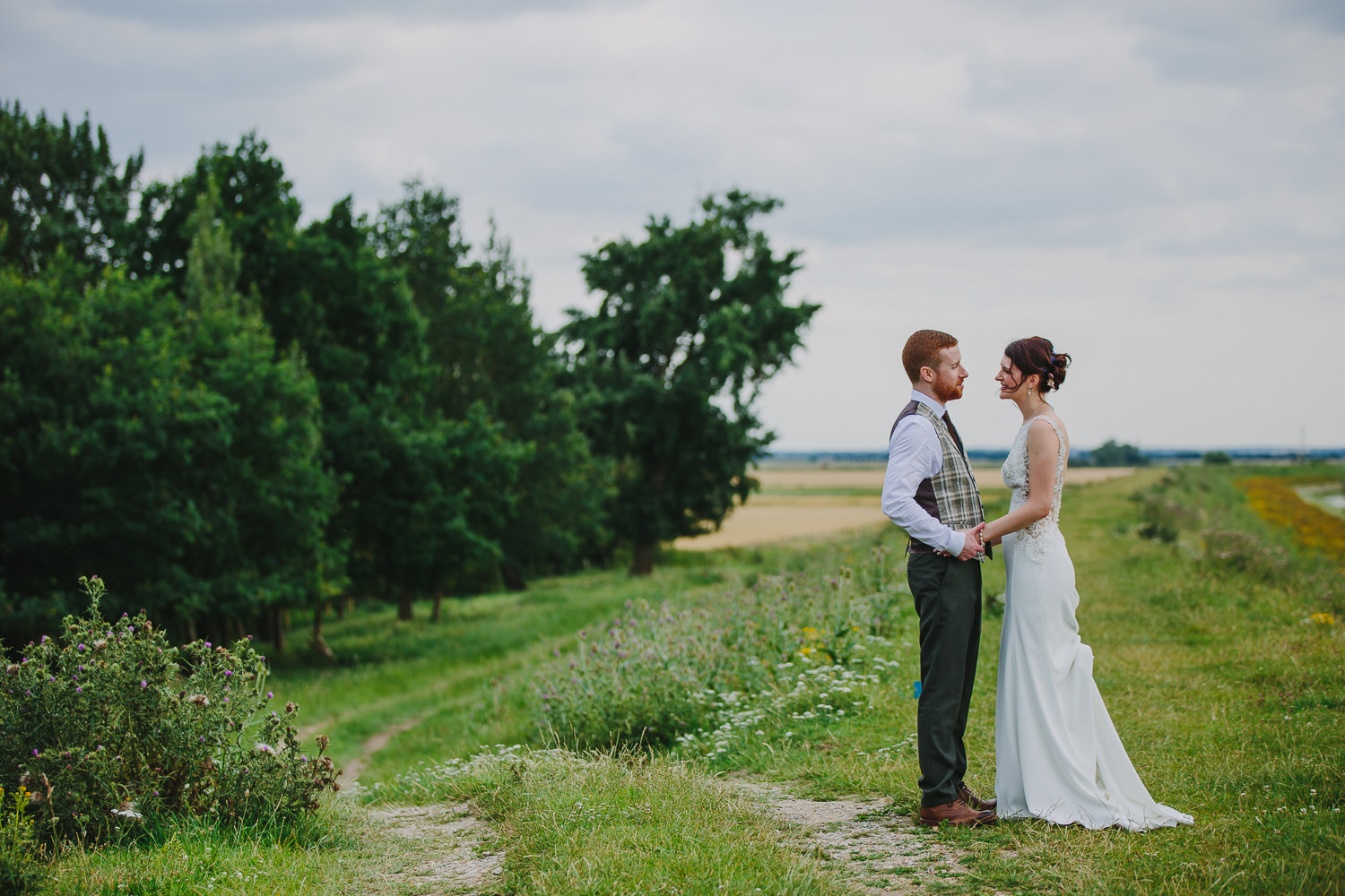 Bride and groom portrait by the river in Sutton, Ely. photographed by an Ely Wedding Photographer