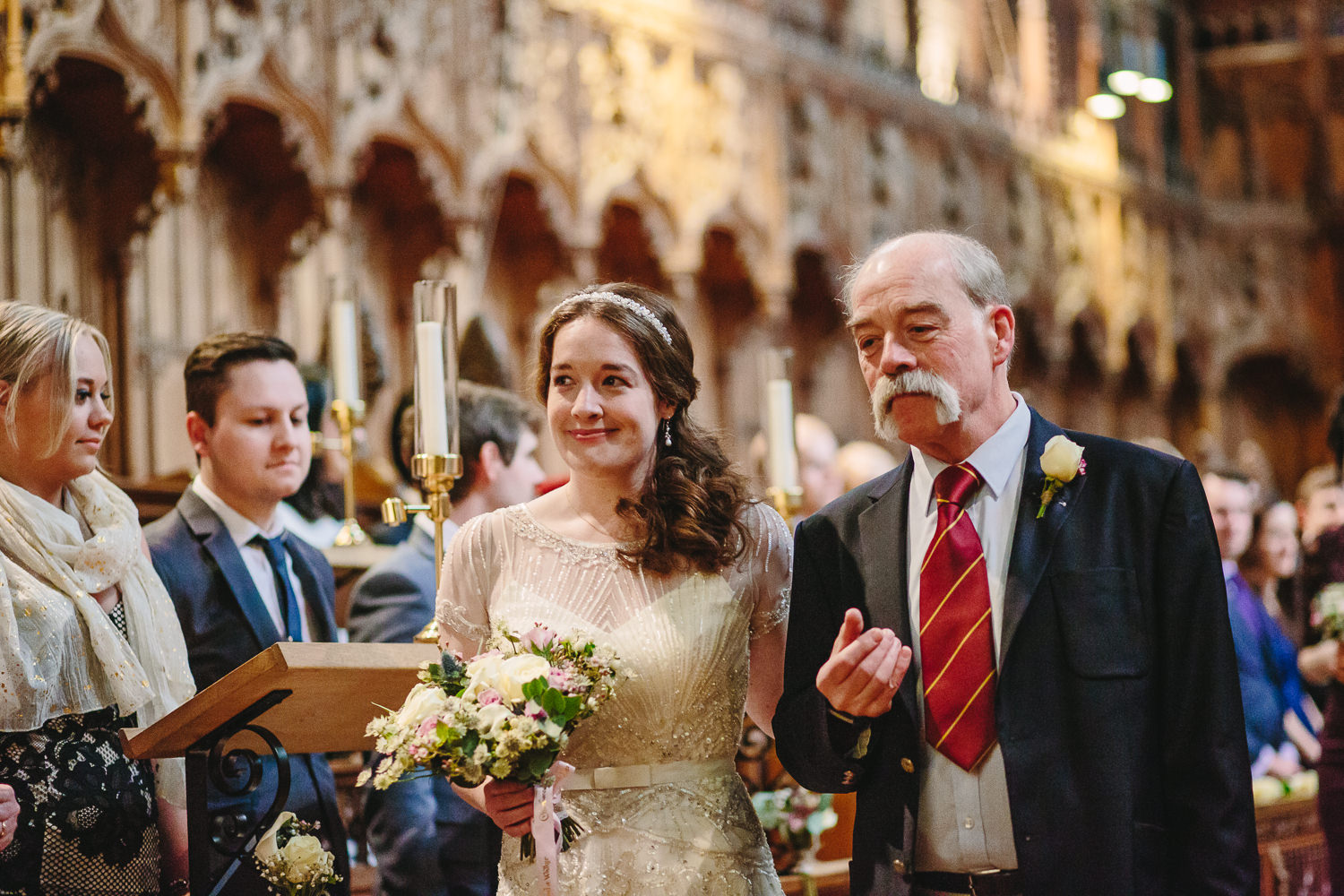Bride and father walking down the aisle at Selwyn College chapel at Cambridge University