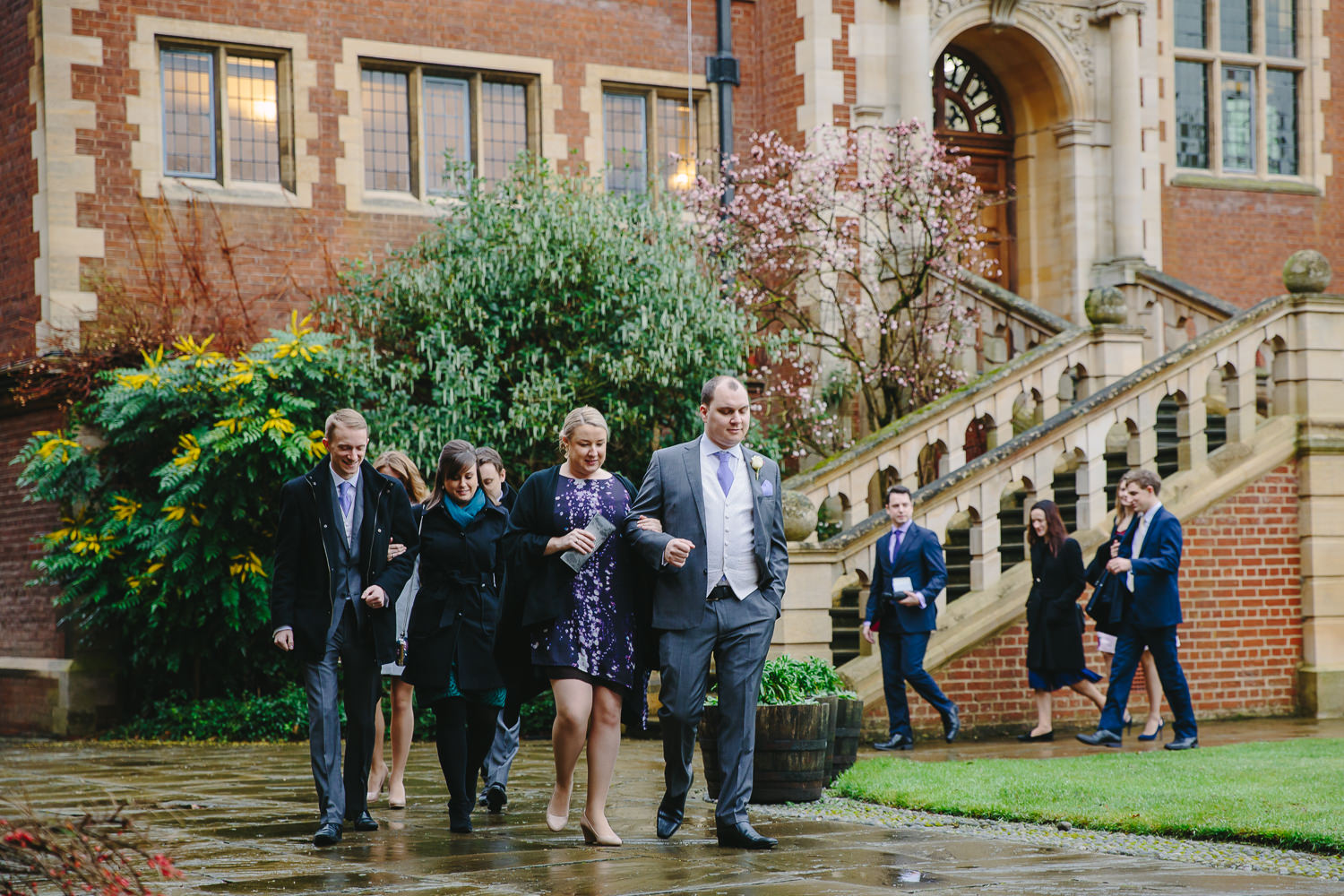 Wedding guests walking by the Old Court at Selwyn College Cambridge University