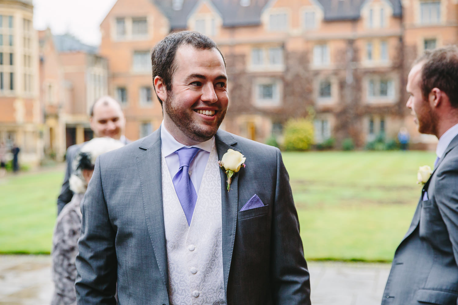 Groom smiling captured by Cambridge University Wedding Photographer, while at the Old Court at Selwyn College