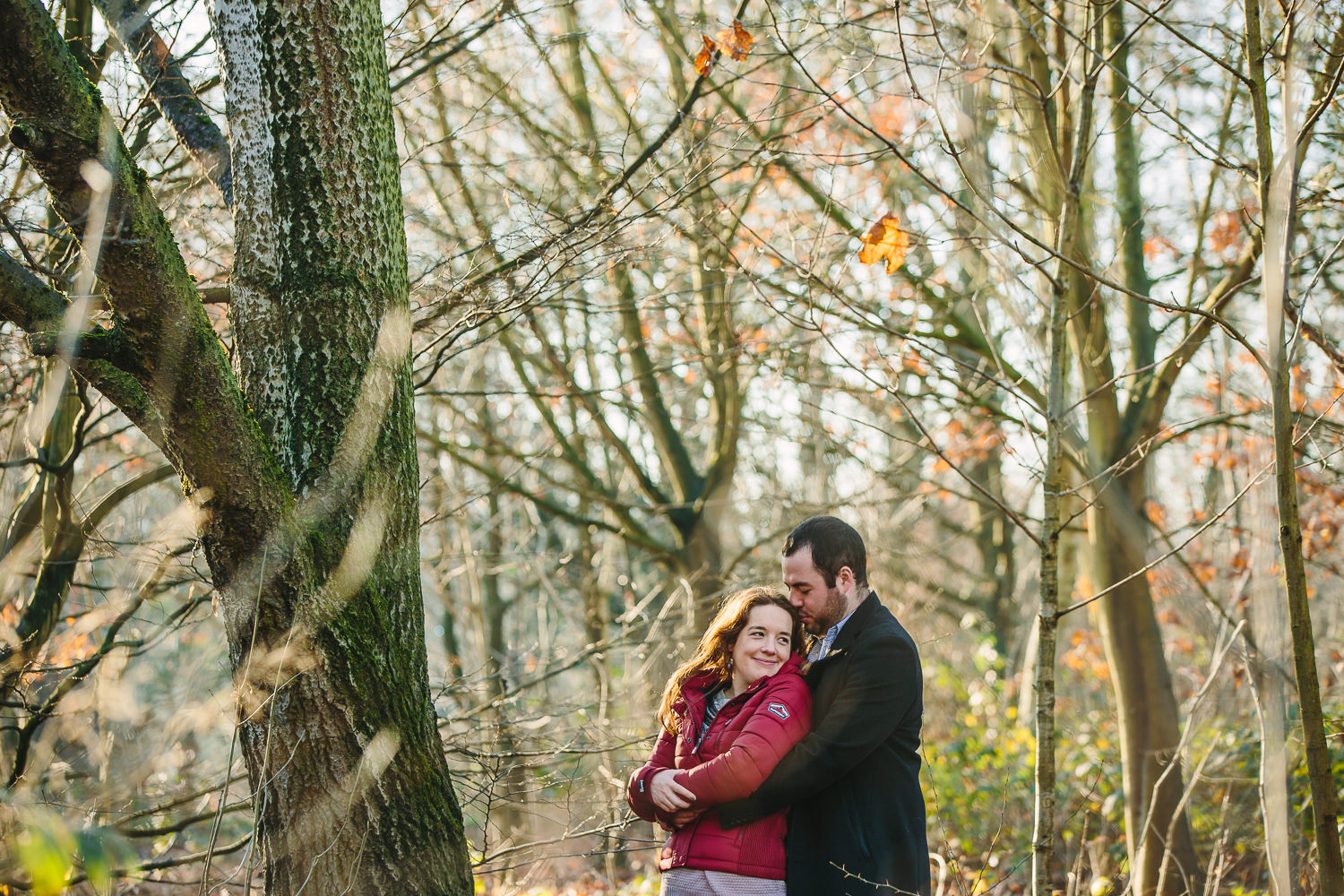 Winter engagement photography photo of a couple in the woodlands of Alexandra palace in London